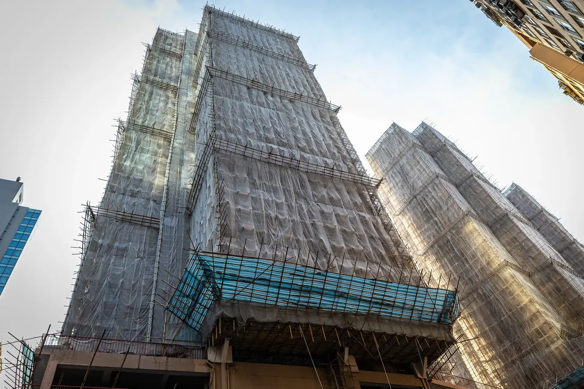 High-rise buildings under construction in Hong Kong, showcasing urban development and modern architecture.