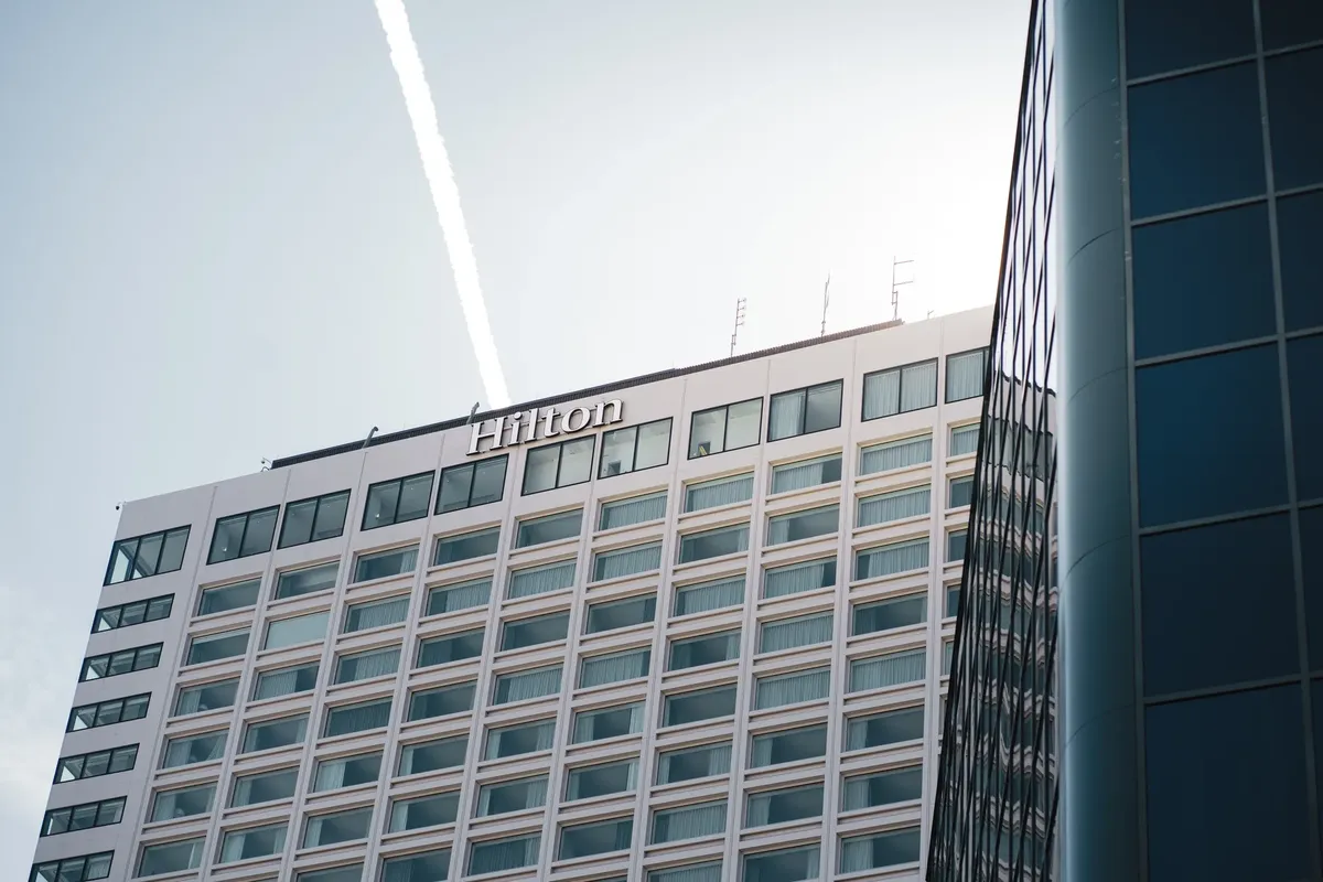 Modern Hilton Hotel building in Québec City captured from a low angle with clear blue skies.